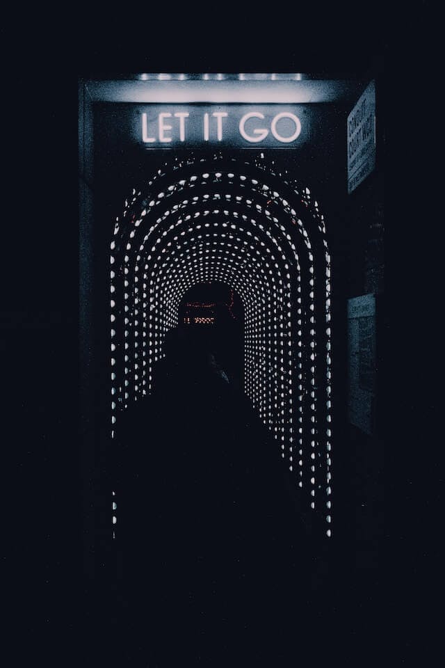a dark tunnel with a sign that says let it go